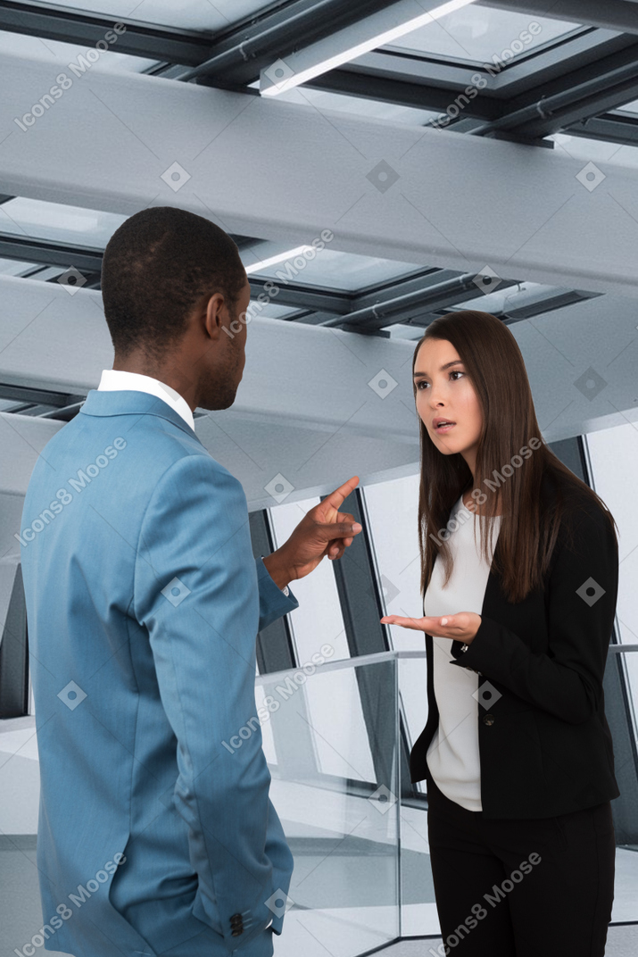 A woman talking to a man in a suit