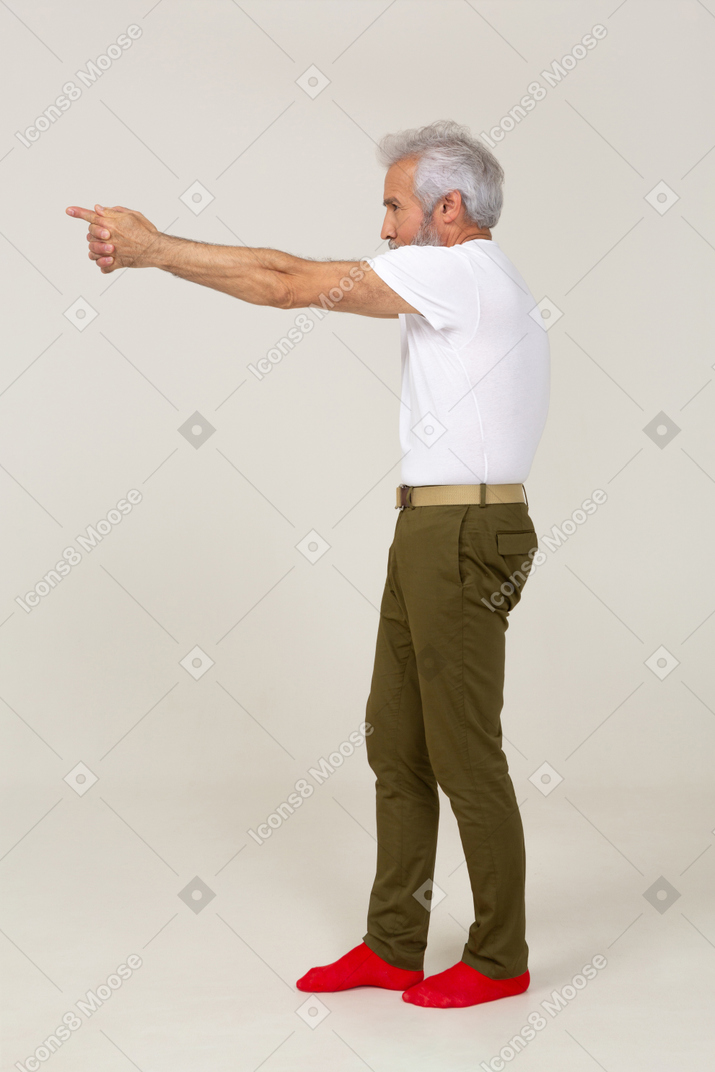 Man in casual clothes aiming a finger gun