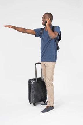 Male tourist talking on the phone and showing to stop with a hand