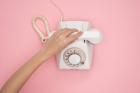 Female hand putting down phone receiver