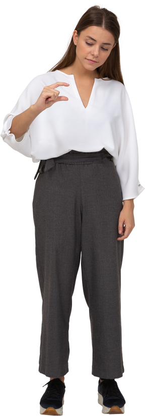 Front view of a young lady in office clothing showing a size of something