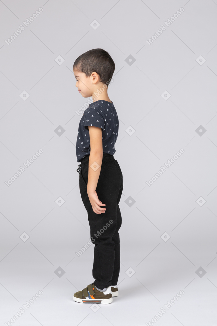 Cute boy in casual clothes posing in profile