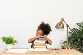 Good looking cute girl with books at the table