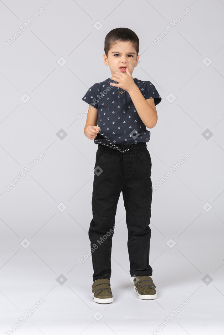 Front view of a cute boy looking at camera and making faces
