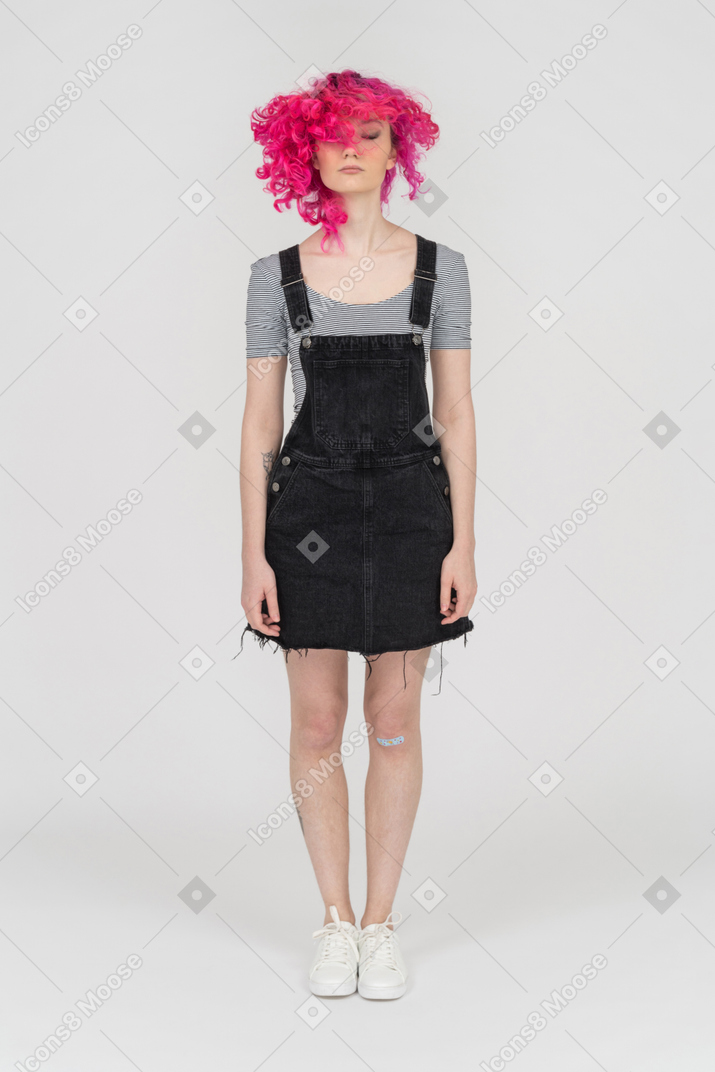 A pink haired girl standing still