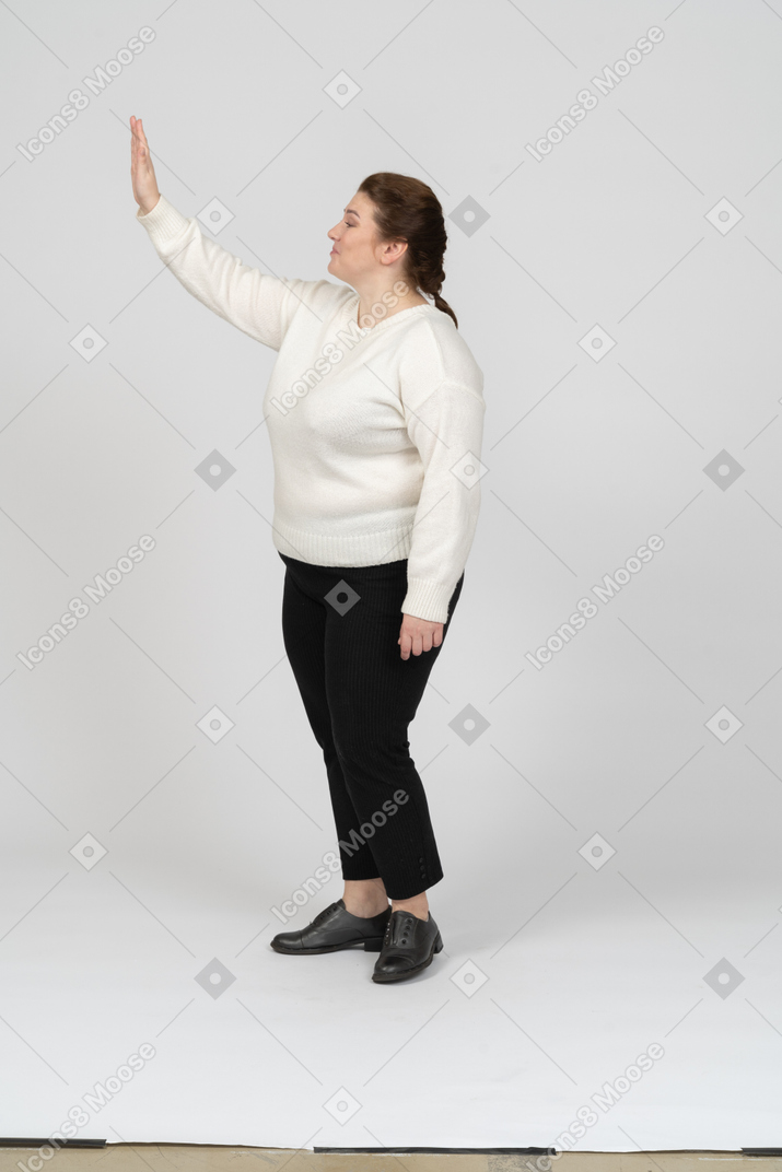Side view of a plump woman in casual clothes gesturing