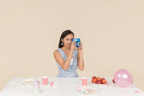 Junge asiatische frau, die geburtstag feiert und ein foto macht