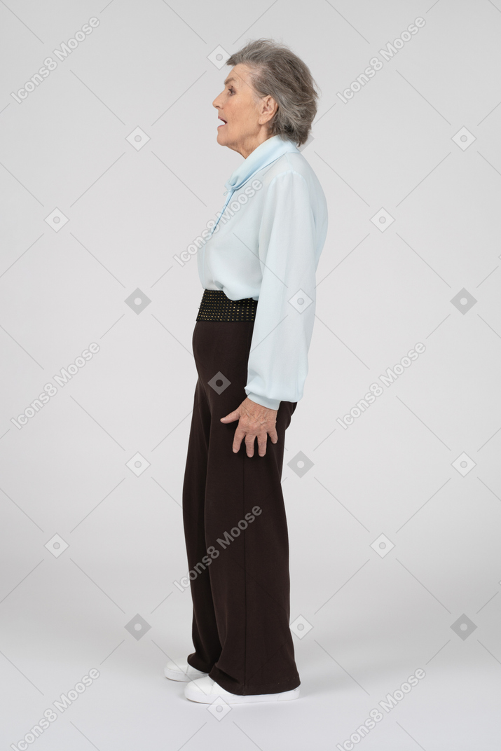 Side view of an old woman looking a bit scared