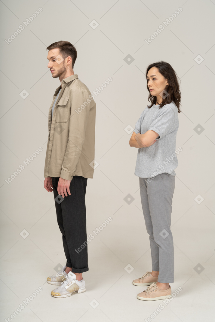 A man and woman standing in front of a wall