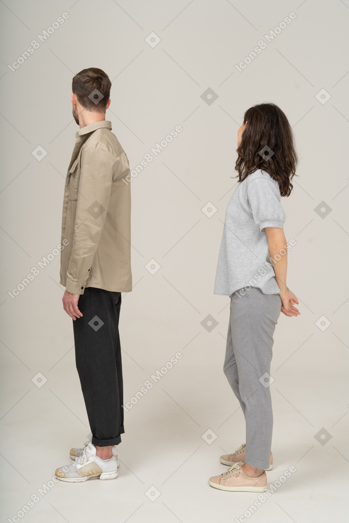 Jeune couple regardant par-dessus les épaules