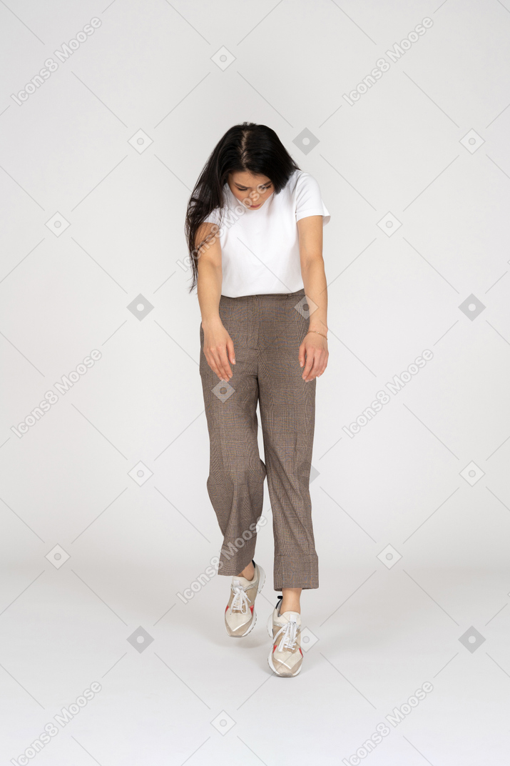 Front view of a young lady in breeches and t-shirt outstretching hands