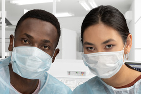 A couple of scientists wearing face masks