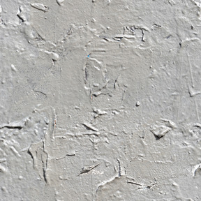 Ancienne couche de peinture fissurée sur mur de béton