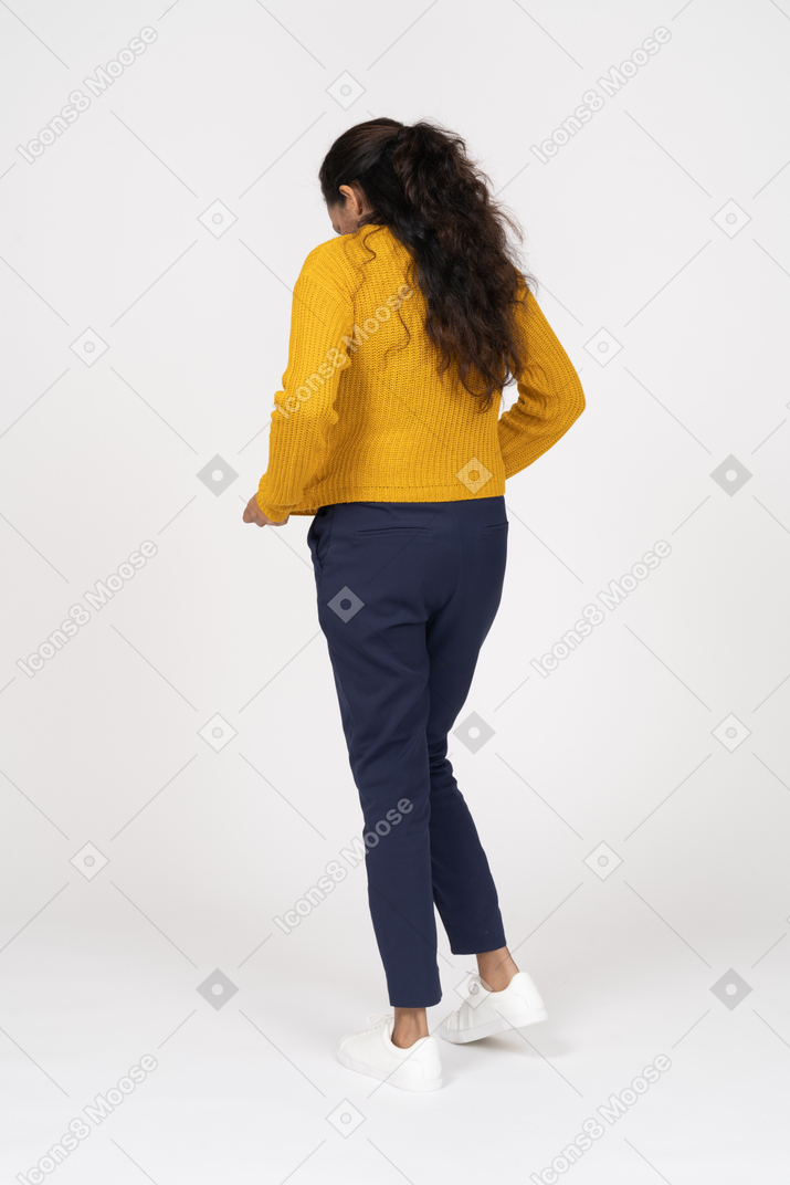 Rear view of a girl in casual clothes checking if her shirt is clean