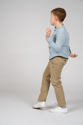 A young boy in a blue shirt dancing
