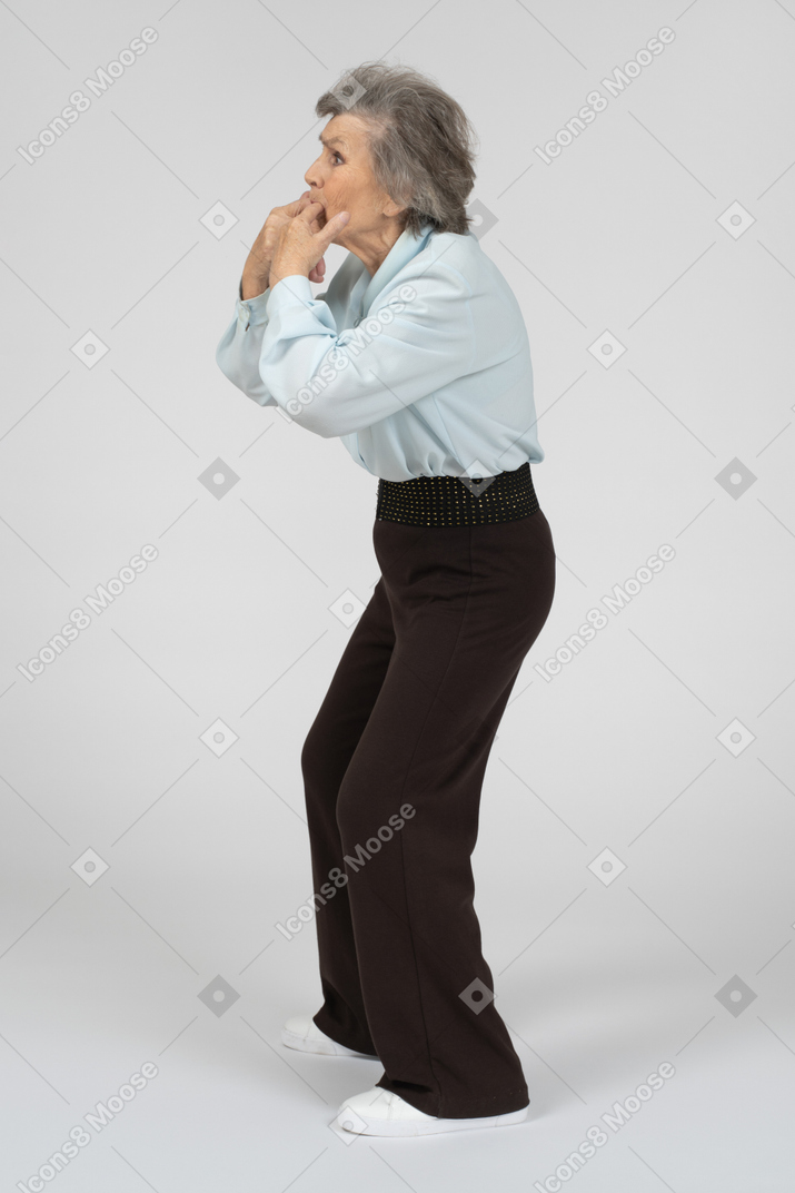 Old woman whistling with her fingers