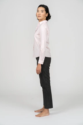 Side view of a woman in office clothes with her head turned to camera