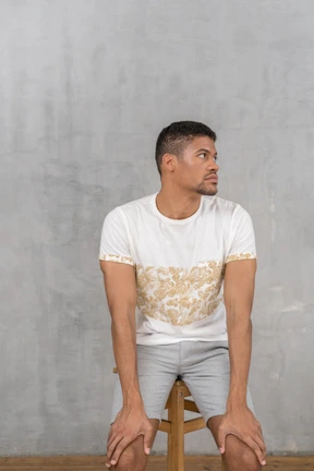 Young man sitting and looking aside