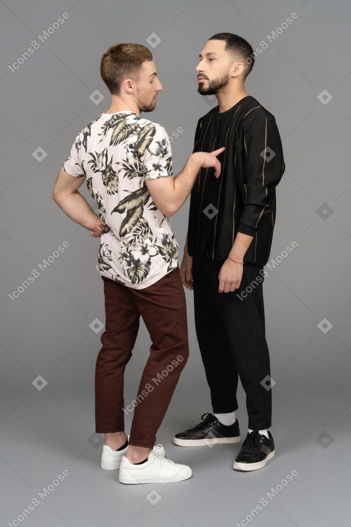 Two young men standing close to each other