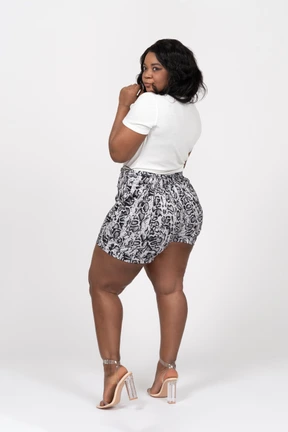Side view of a fashionable young woman looking at camera