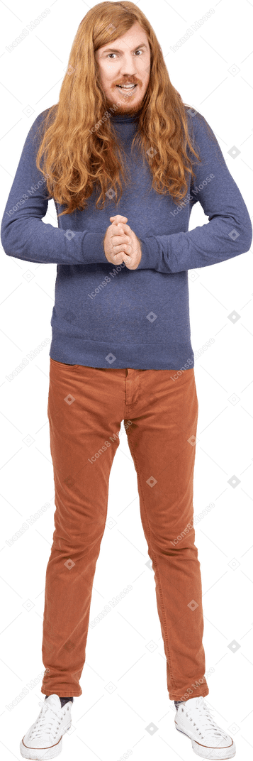 Young man in casual clothes looks at camera