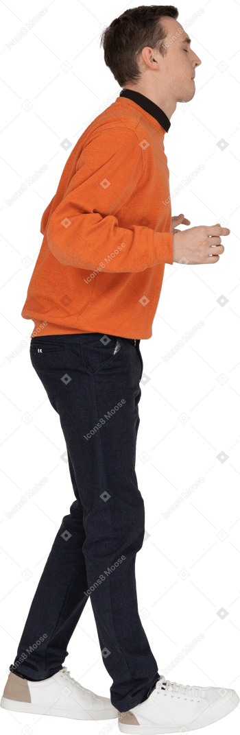 Young man in orange sweatshirt dancing