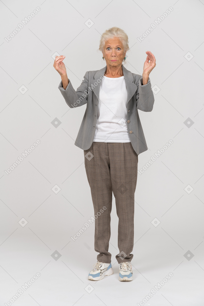 一位身着西装、双臂高举的老妇人的前视图