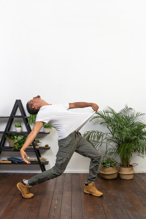 Handsome athletic man posing on the background of the apartment