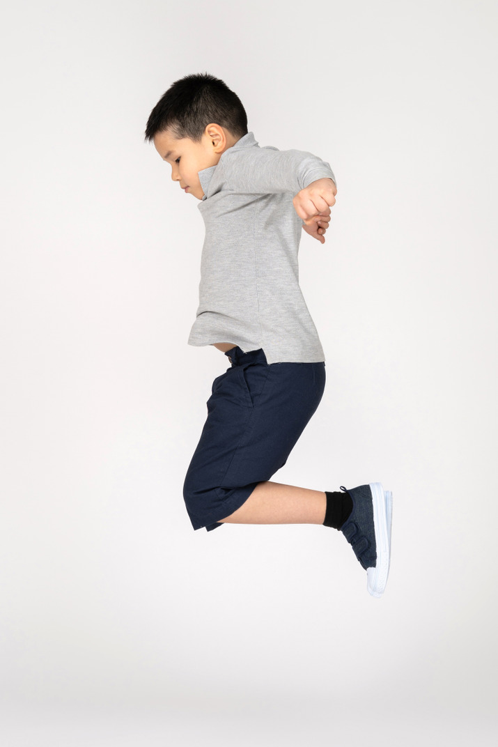 Jumping boy in profile