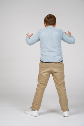 Back view of a boy scaring someone