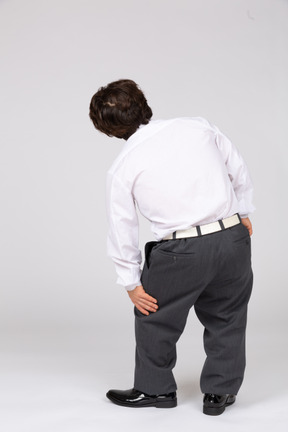 Back view of man groaning with leg pain