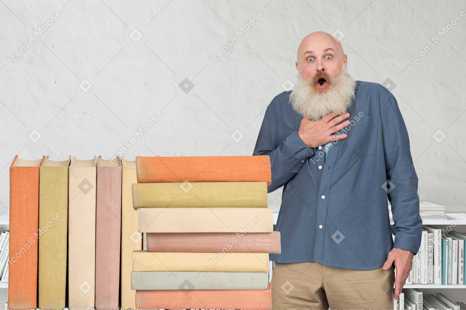 Surprised man standing next to a stack of giant books