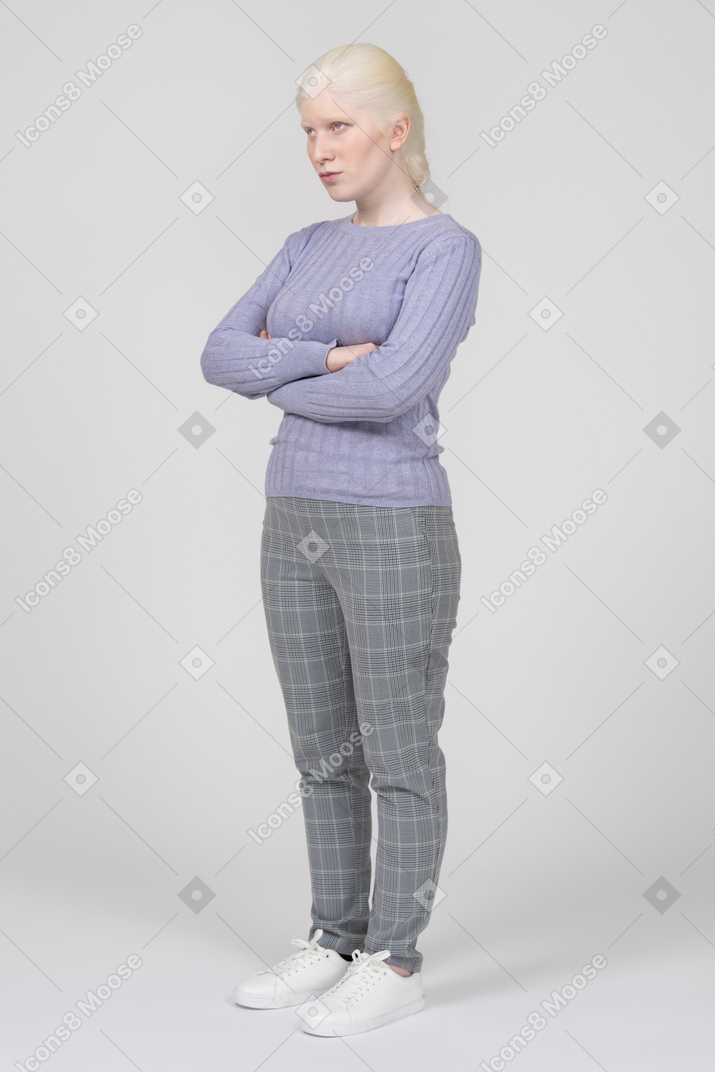 Annoyed young woman standing with arms crossed