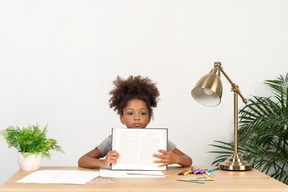 Good looking cute girl with books at the table