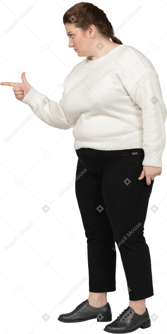 Side view of a plump woman in casual clothes pointing with a finger