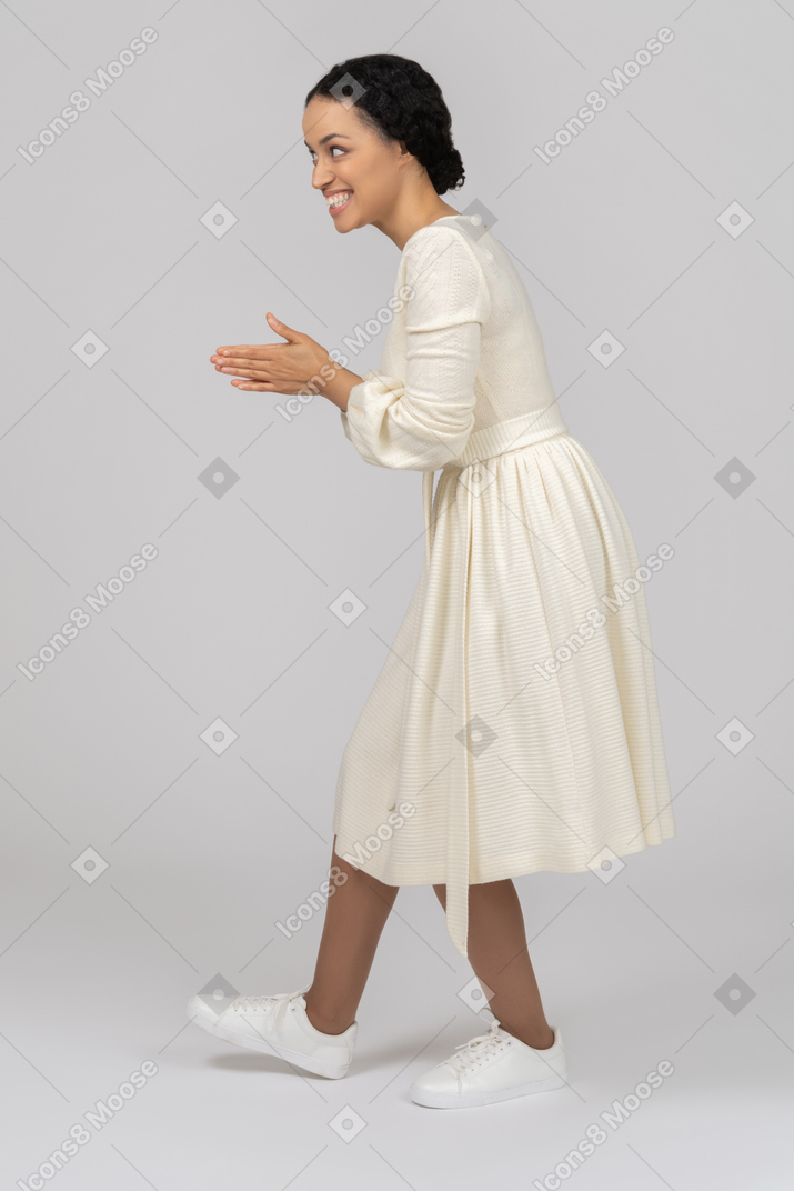 Excited young woman clapping hands