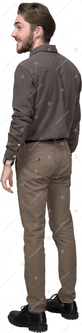 Three-quarter back view of a delighted young man in office clothing