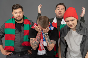 Close-up of four upset male football fans