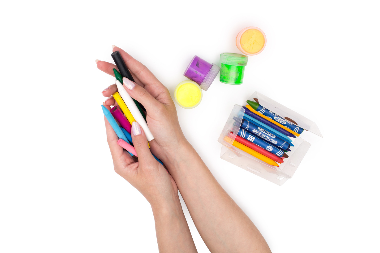 Hands holding multicolored crayons