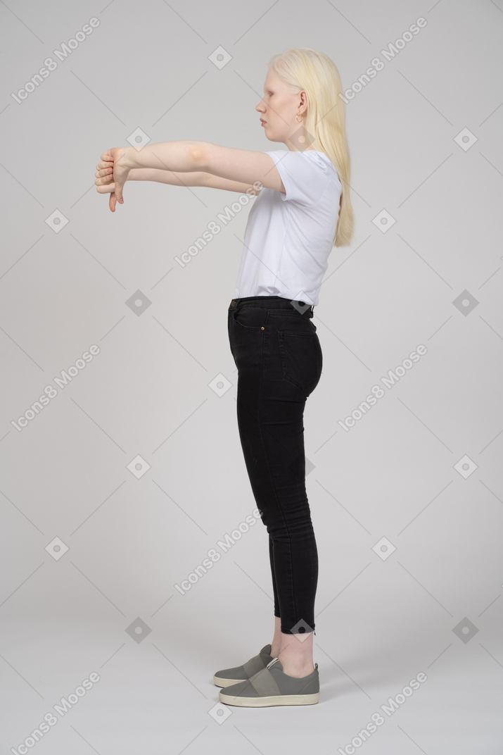 Side view of a young girl showing two thumbs down