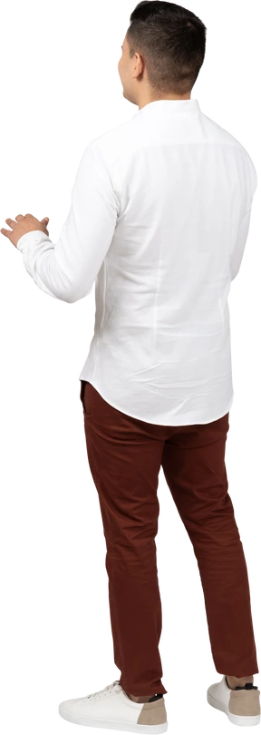 Three-quarter back view of a young latino man raising hands slightly