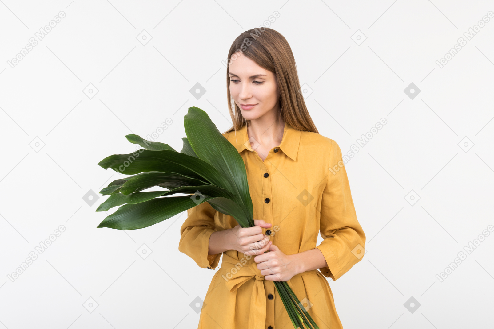 Young woman holding green leaves