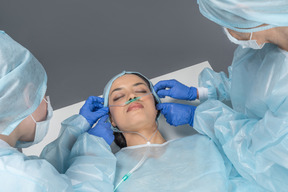 Doctors making last preparations berofe young woman's operation
