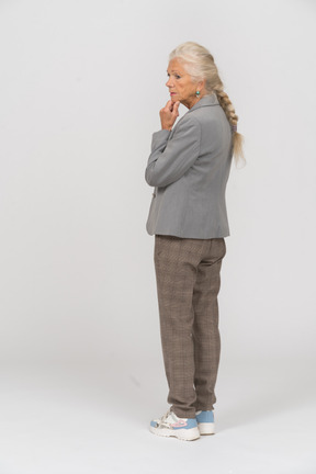 Rear view of a thoughtful old lady in suit