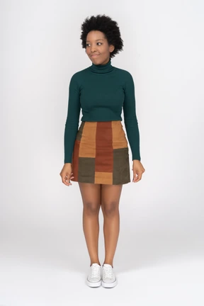 Cute smiling afro-american girl standing still and looking aside