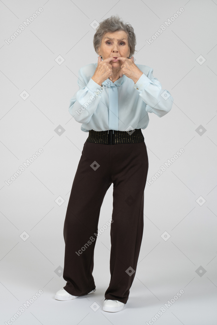 Old woman whistling with her fingers