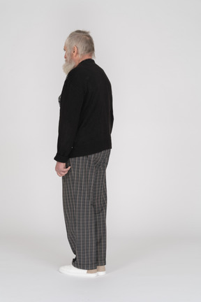 Rear view of old man standing straight