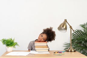 Good looking cute girl with books at the table