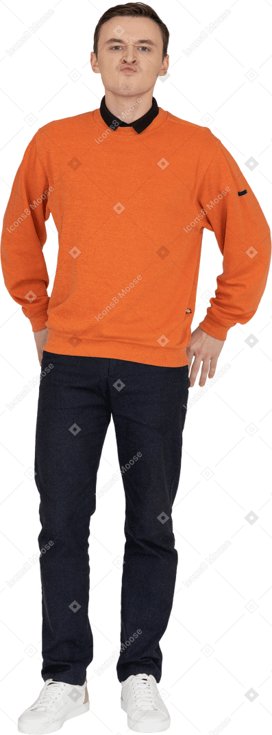 Young man in orange sweatshirt standing