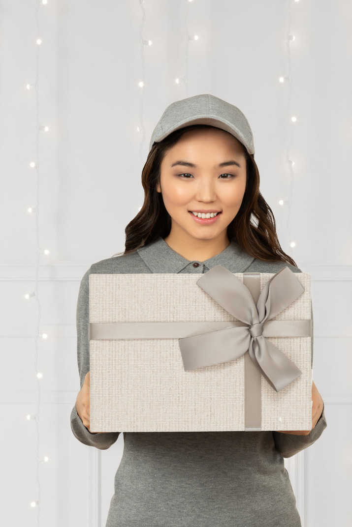 Asian woman bringing christmas present